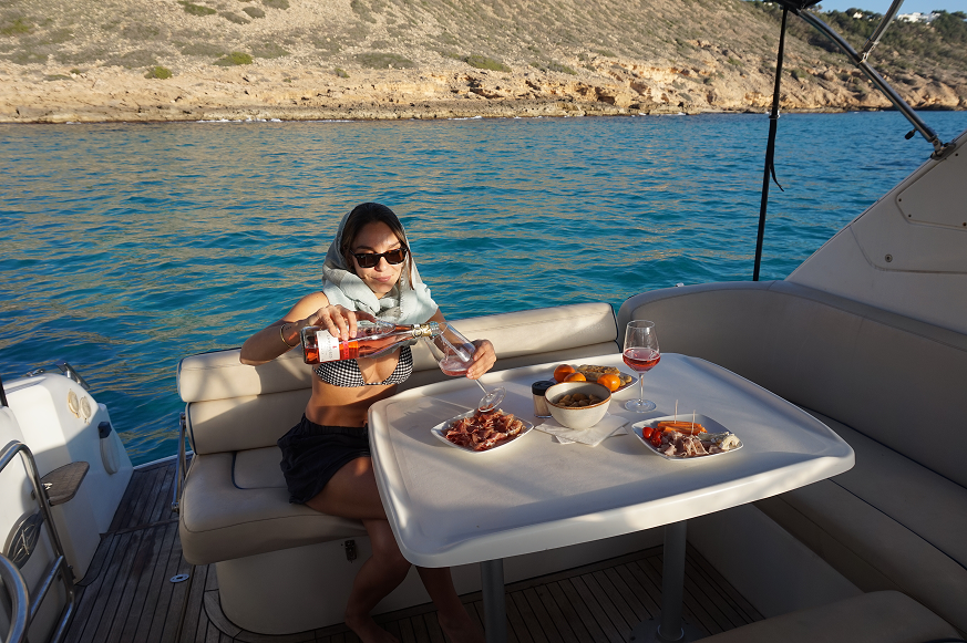 Woman drinking mallorca wine in a yacht