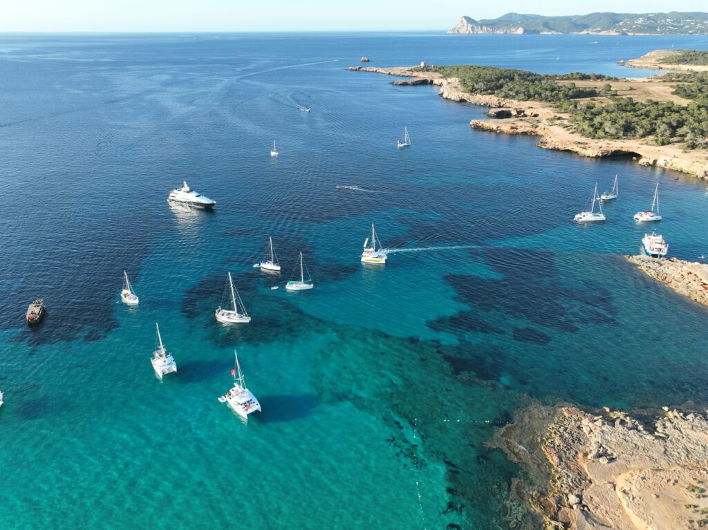 Beach in ibiza with yachts charters